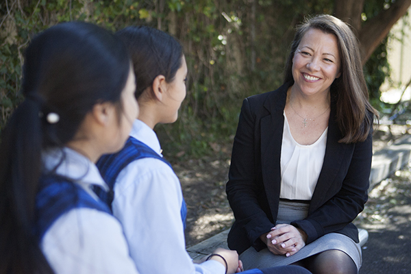 Principal seating down talking to students