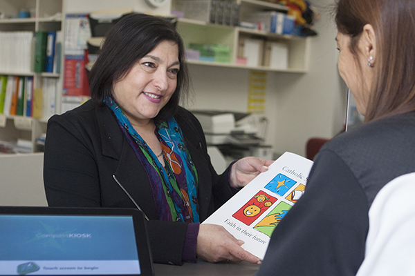 school staff member giving information to parent